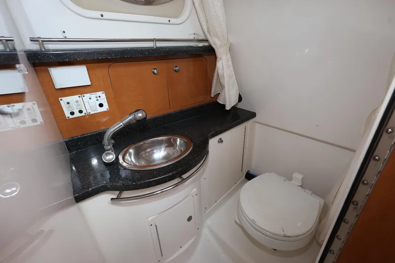 Slide: The Image of 2012 Robalo R305 Walkaround boat bathroom with sink and toilet. - 21
