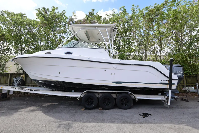 Slide: The Image of 2012 Robalo R305 Walkaround boat on trailer, parked outdoors. - 28