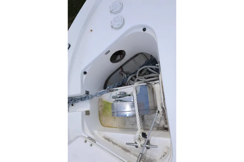 Slide: The Image of Anchor compartment of 2012 Robalo R305 Walkaround boat with ropes and chain. - 8