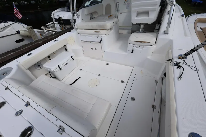 Slide: The Image of 2012 Robalo R305 Walkaround boat interior with seating and storage compartments. - 9