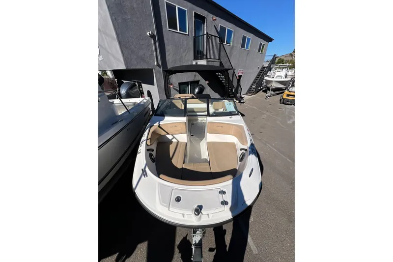 Slide: The Image of 2023 Sea Ray SPX 190 Outboard boat with tan interior, parked outdoors. - 1