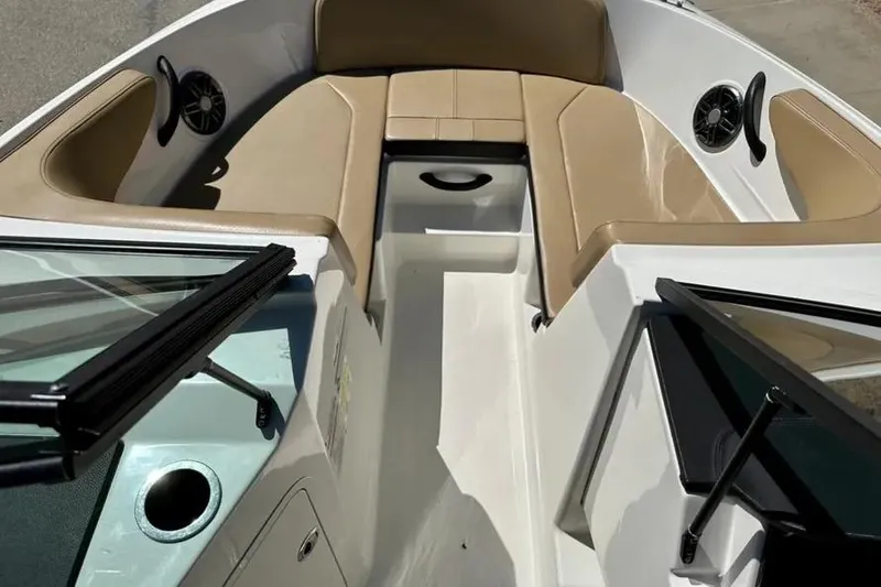 Slide: The Image of 2023 Sea Ray SPX 190 Outboard boat interior with tan seating and speakers. - 11