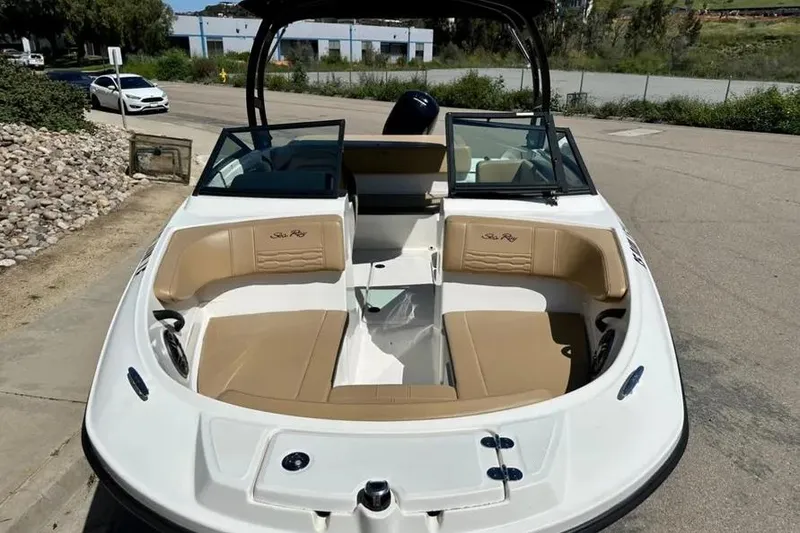 Slide: The Image of 2023 Sea Ray SPX 190 Outboard boat with tan seating, parked on a sunny day. - 12