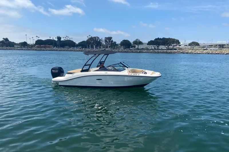 Slide: The Image of 2023 Sea Ray SPX 190 Outboard boat cruising on calm water under a clear sky. - 3