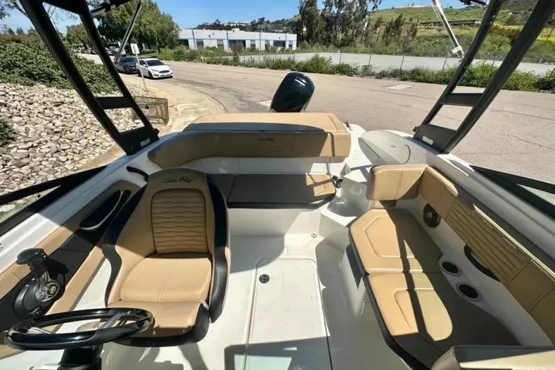 Slide: The Image of 2023 Sea Ray SPX 190 Outboard boat interior with tan seating and steering wheel. - 8