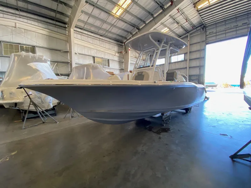 The Image of 2026 Key West 219 FS boat in a spacious indoor storage facility. - 0