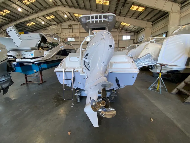 Slide: The Image of 2026 Key West 219 FS boat in a showroom, rear view with outboard motor. - 4