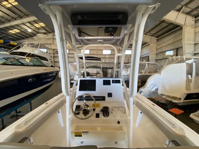Slide: The Image of 2026 Key West 219 FS boat interior with steering console in a showroom. - 6