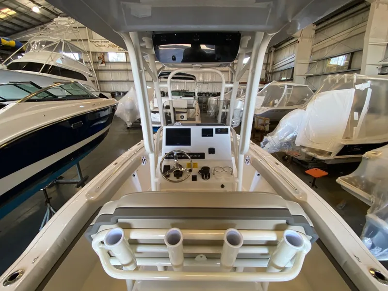 Slide: The Image of 2026 Key West 219 FS boat interior in showroom, featuring helm and seating area. - 7