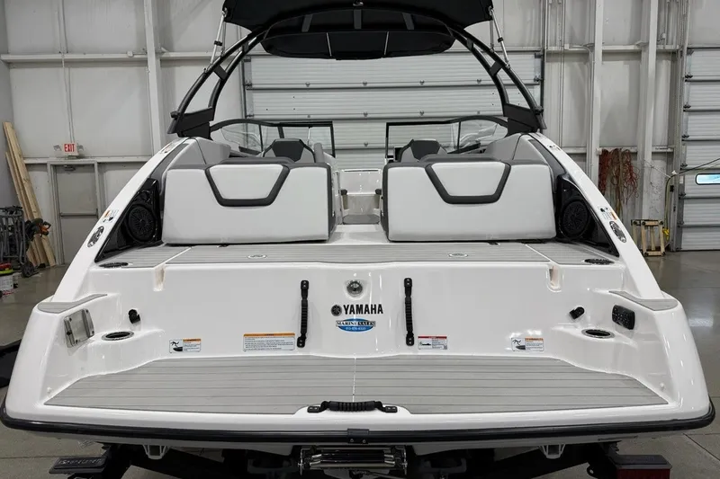 Slide: The Image of 2025 Yamaha Boats AR250, rear view in a garage setting, showcasing sleek design and features. - 4