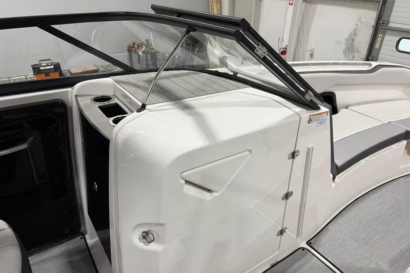 Slide: The Image of 2025 Yamaha Boats AR250 interior with windshield, cup holders, and seating area. - 7