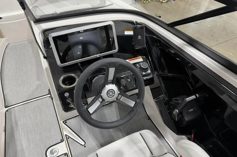 Slide: The Image of 2025 Yamaha AR250 boat cockpit with steering wheel and touchscreen display. - 8