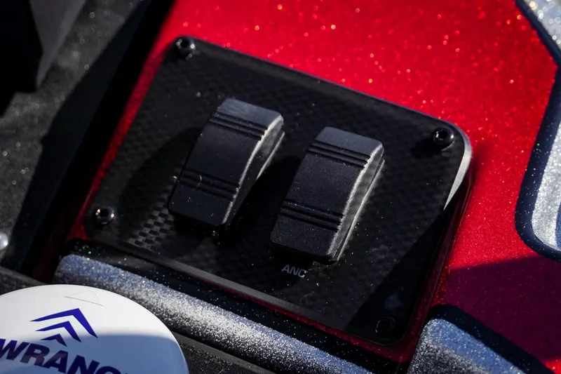 Slide: The Image of Close-up of 2024 Triton 20XP boat controls on a sparkling red surface. - 11