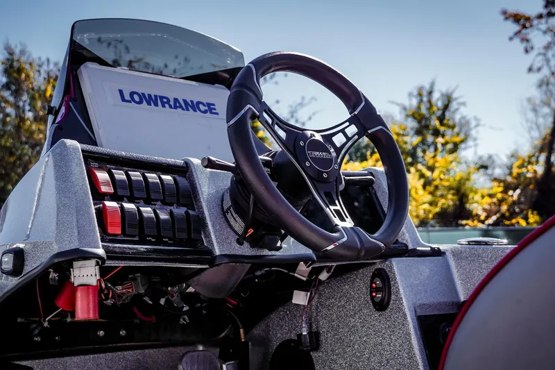 Slide: The Image of 2024 Triton 20XP boat dashboard with Lowrance display and steering wheel. - 12