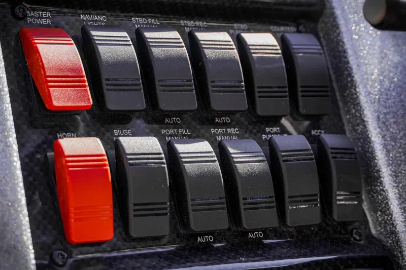 Slide: The Image of Control panel of 2024 Triton 20XP boat with switches for various functions. - 13