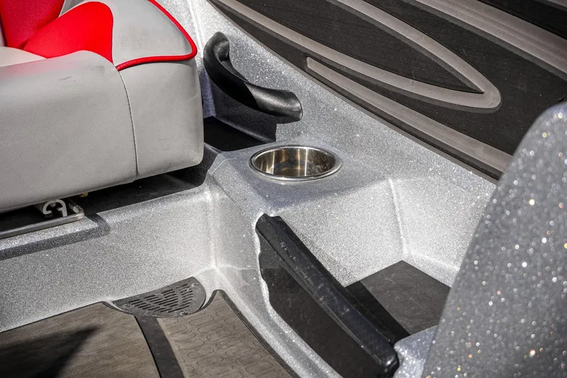 Slide: The Image of 2024 Triton 20XP boat interior with gray and red seating, cup holder, and textured flooring. - 16