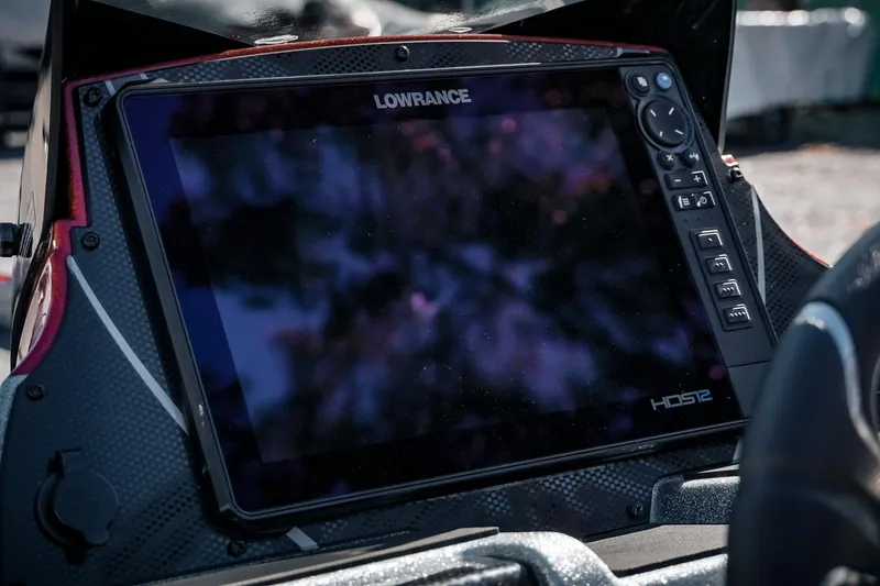 Slide: The Image of Lowrance HDS12 display on 2024 Triton 20XP boat dashboard, featuring control buttons and carbon fiber finish. - 19