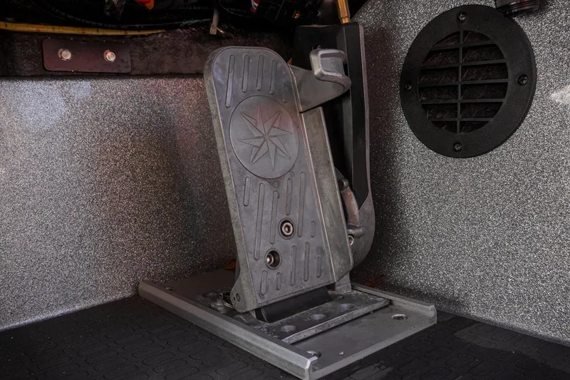 Slide: The Image of 2024 Triton 20XP boat foot pedal with textured surface and star emblem. - 21