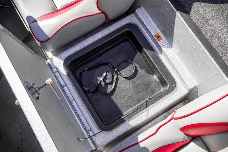 Slide: The Image of 2024 Triton 20XP boat storage compartment with red and gray seating. - 28
