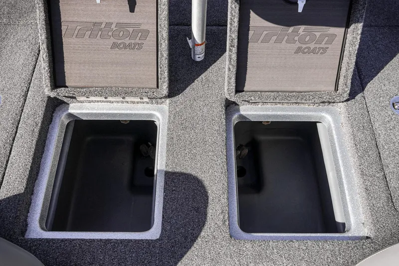 Slide: The Image of 2024 Triton 20XP boat storage compartments with open lids, showcasing interior space. - 29