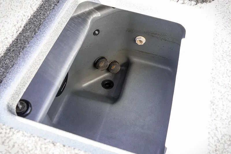 Slide: The Image of 2024 Triton 20XP boat compartment interior with drainage system and textured surface. - 30