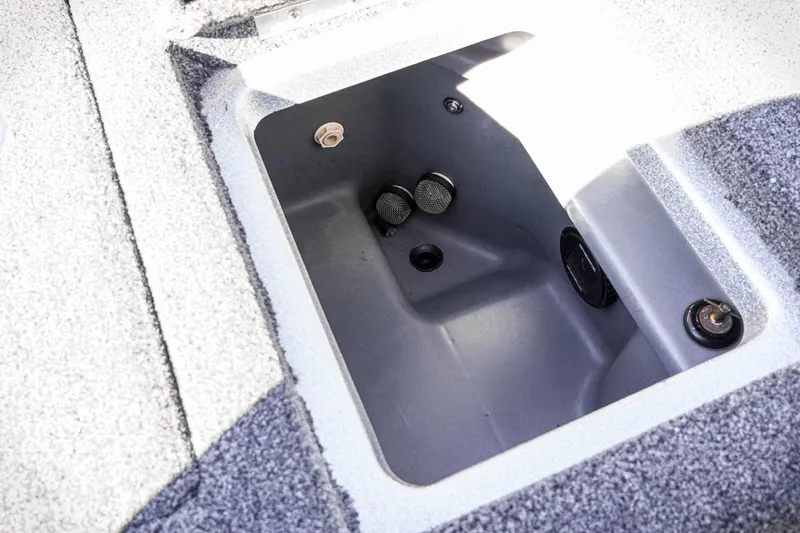 Slide: The Image of 2024 Triton 20XP boat storage compartment with gray interior and drainage features. - 31