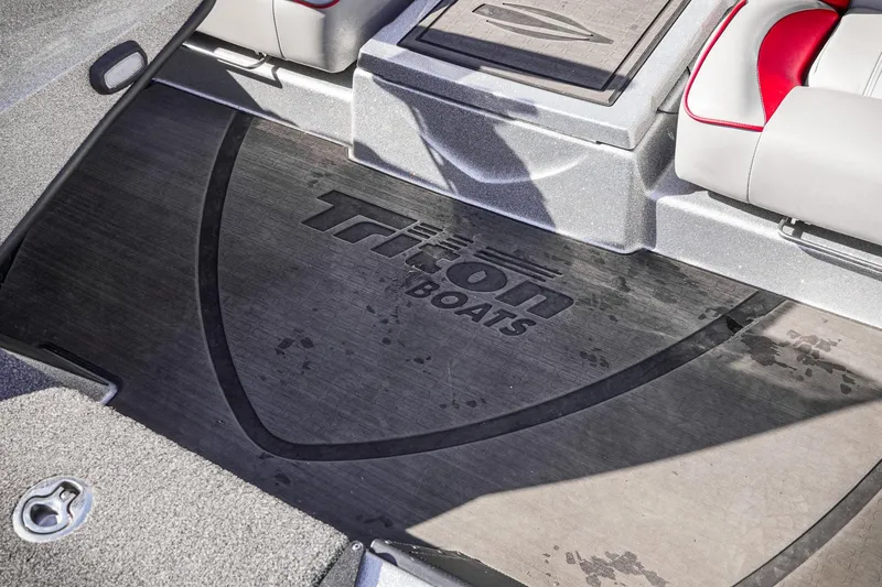 Slide: The Image of 2024 Triton 20XP boat interior with logo on floor mat, featuring sleek seating design. - 32