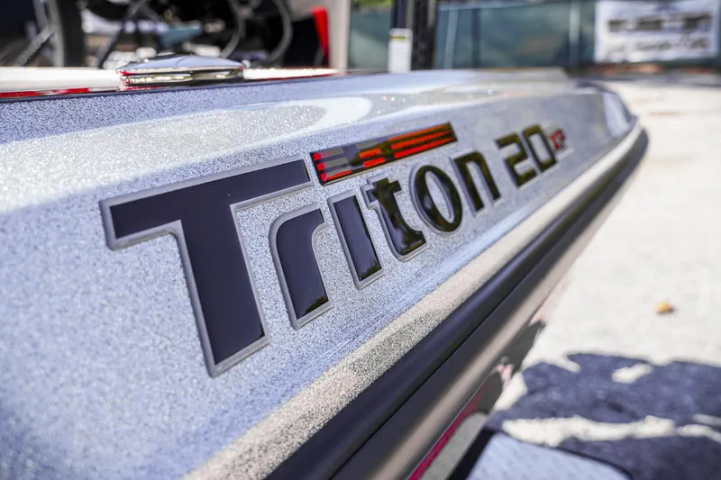 Slide: The Image of 2024 Triton 20XP boat logo close-up with metallic finish. - 37