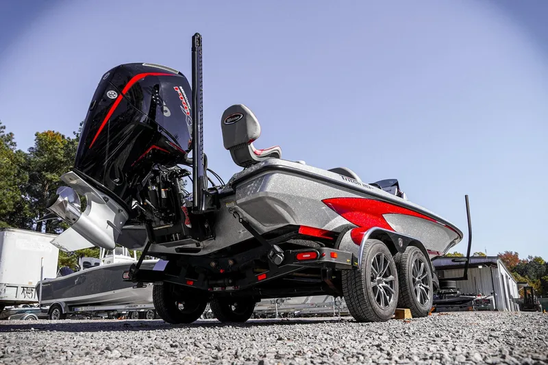 Slide: The Image of 2024 Triton 20XP boat with powerful engine and sleek design on a trailer. - 38