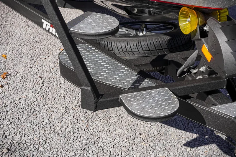 Slide: The Image of 2024 Triton 20XP trailer with diamond plate steps on gravel surface. - 40