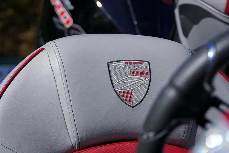 Slide: The Image of 2024 Triton 20XP boat seat with embroidered logo, featuring gray and red upholstery. - 43