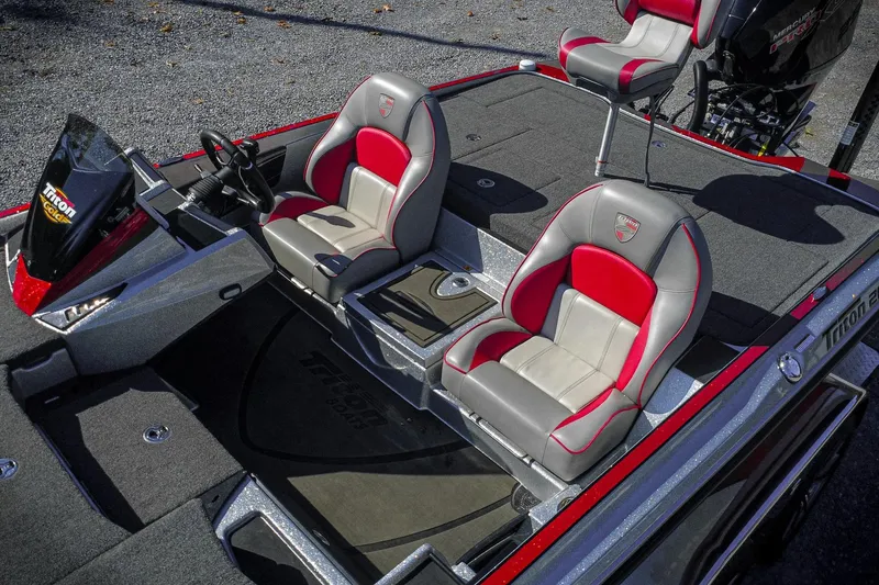 Slide: The Image of 2024 Triton 20XP boat interior with red and gray seating, steering console, and carpeted deck. - 6