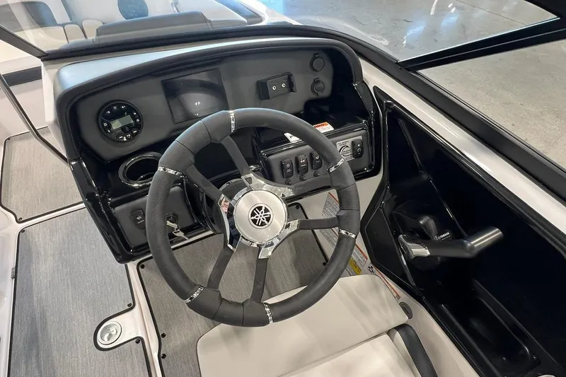 Slide: The Image of 2025 Yamaha AR195 boat cockpit with steering wheel and control panel. - 5