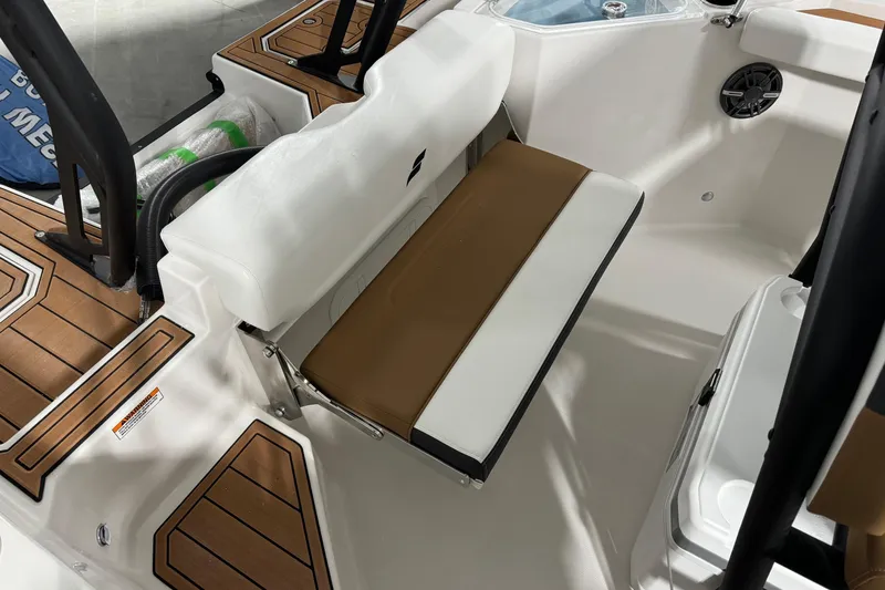 Slide: The Image of 2025 Starcraft SVX 211 OB CC boat interior with cushioned seating and teak-style flooring. - 18