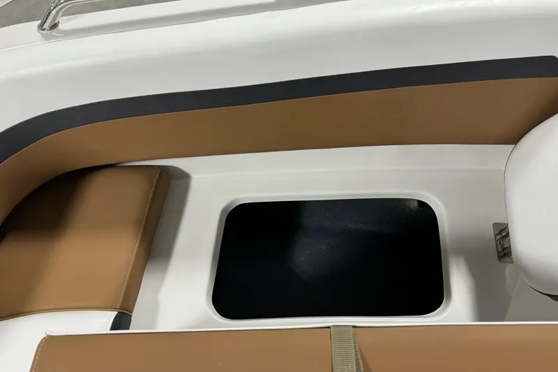 Slide: The Image of 2025 Starcraft SVX 211 OB CC boat interior with tan and white seating. - 9