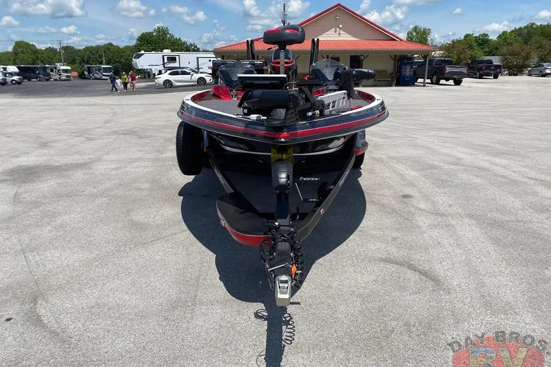 Slide: The Image of 2020 Ranger Z520L boat parked in a lot, surrounded by vehicles and a building. - 10