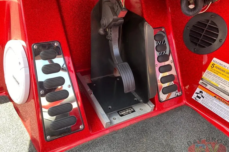 Slide: The Image of 2020 Ranger Z520L boat foot pedal and control panel in red interior. - 101