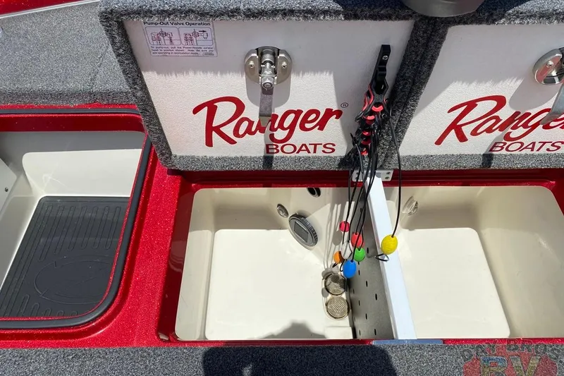 Slide: The Image of 2020 Ranger Z520L boat storage compartments with fishing rod holders and pump-out valve instructions. - 106