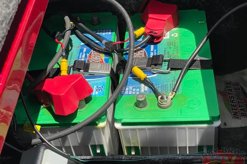 Slide: The Image of 2020 Ranger Z520L boat batteries with Interstate branding and connected cables. - 113