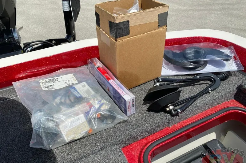 Slide: The Image of 2020 Ranger Z520L boat accessories and parts on deck, including box and packaged items. - 114