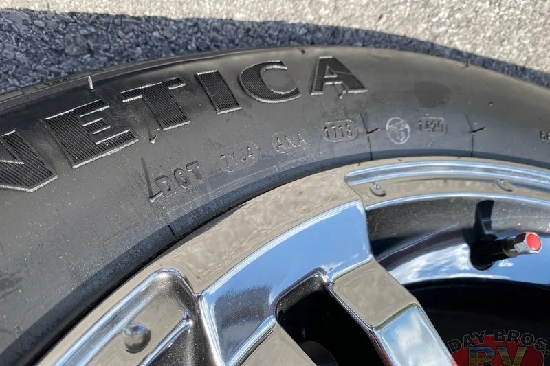 Slide: The Image of Close-up of a 2020 Ranger Z520L tire and chrome wheel on asphalt. - 32