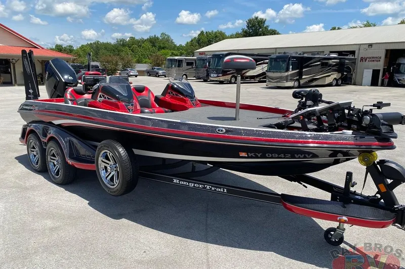 Slide: The Image of 2020 Ranger Z520L boat with red and black design, parked at RV service center. - 4