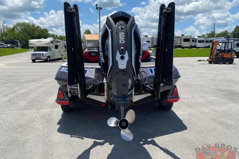Slide: The Image of 2020 Ranger Z520L boat with Evinrude engine, parked outdoors under a cloudy sky. - 40