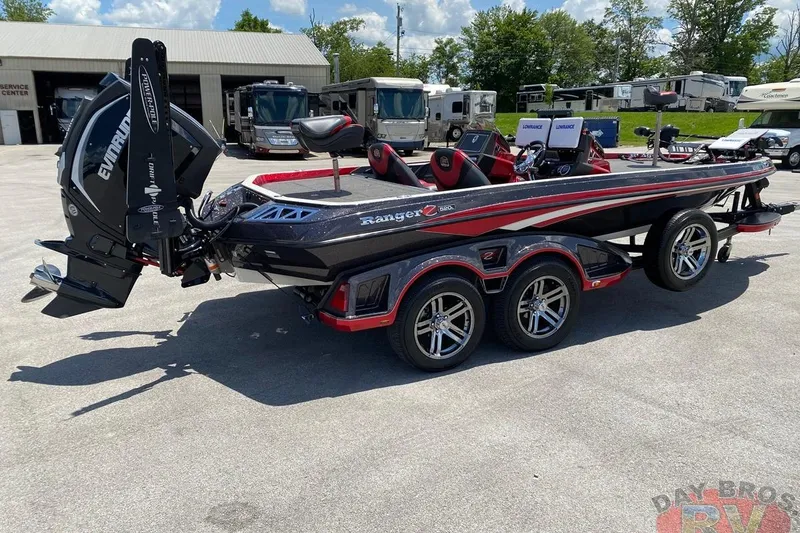 Slide: The Image of 2020 Ranger Z520L boat with Evinrude engine, parked outdoors near RVs. - 47