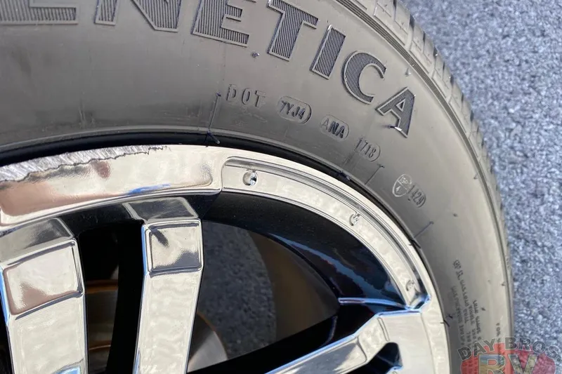 Slide: The Image of Close-up of a 2020 Ranger Z520L tire and chrome wheel on asphalt. - 49