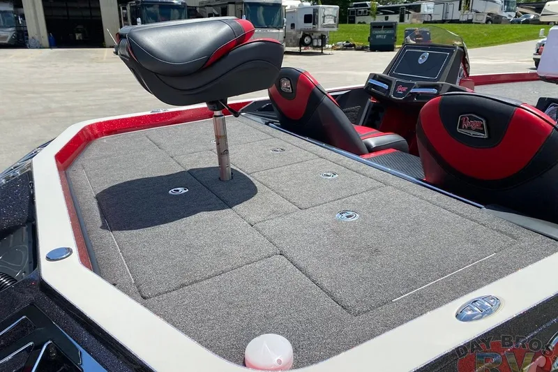 Slide: The Image of 2020 Ranger Z520L boat with cushioned seating and carpeted deck in outdoor setting. - 50