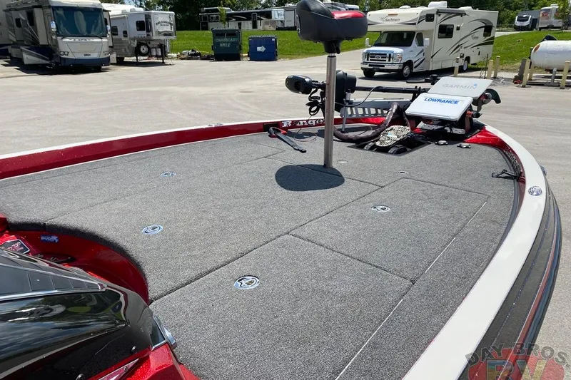 Slide: The Image of 2020 Ranger Z520L boat deck with fishing seat and equipment, parked near RVs. - 54
