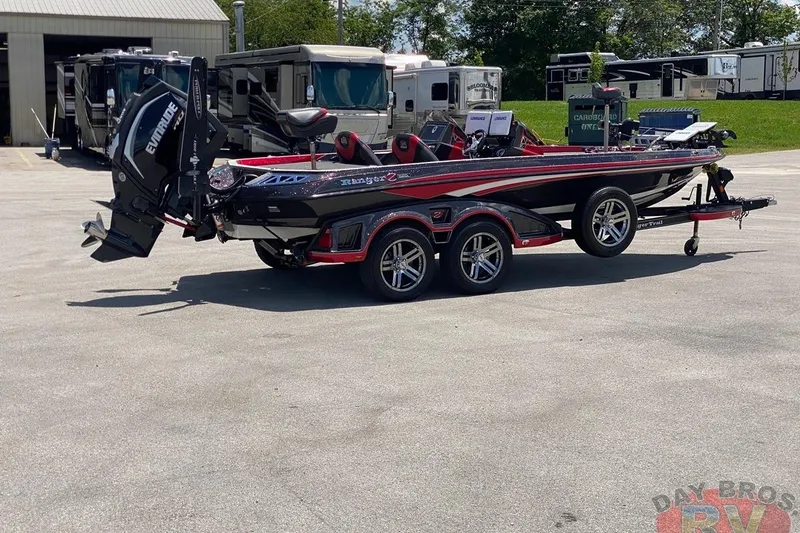 Slide: The Image of 2020 Ranger Z520L boat with Evinrude engine on trailer, parked near RVs. - 55