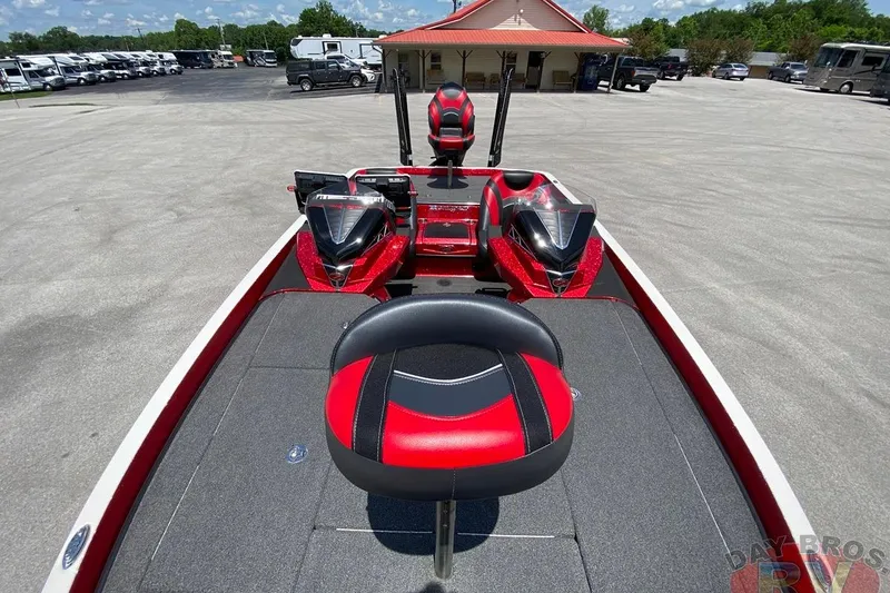 Slide: The Image of 2020 Ranger Z520L boat with red and black seating, parked outdoors. - 6