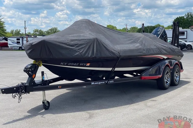 Slide: The Image of 2020 Ranger Z520L boat covered on trailer in parking lot under cloudy sky. - 7